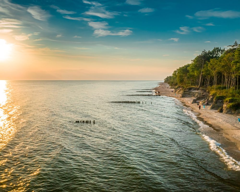 Beach by Baltic sea in Poland. Aerial view of sunset beach. Tourism in Poland.
